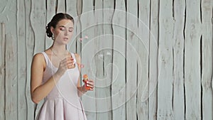 2 shots. Sensual woman with make-up and elegant hairstyle blowing bubbles