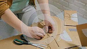 2 shots. Two professional women decorators making envelopes at workshop