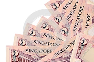 2 Singaporean dollars bills lies in different order isolated on white. Local banking or money making concept