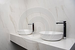 2 sinks with mixer in a bathroom with marble finishes