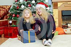 2 sisters by the Christmas tree.