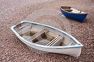 2 small boats on pebble beach