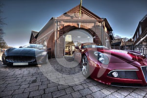 2 Sports cars parked outside a building