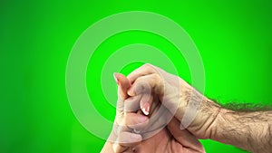 2 strong male hairy hands pinch Woman hand gently with french manicure on green background space for text background