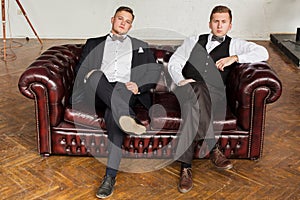 2 successful guys on the couch in a business style. Modern young business. Copy space