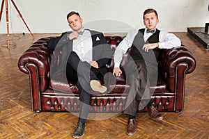 2 successful guys on the couch in a business style. Modern young business. Copy space