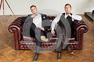 2 successful guys on the couch in a business style. Modern young business. Copy space