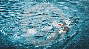 2 swimming boys, above view