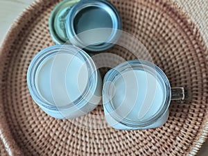 2 Two glasses of mason jars with natural homemade plain yoghurt, yogurt, on the handwoven rattan tray, rounded shape wicker basket