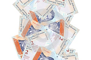2 Venezuelian bolivar bills flying down isolated on white. Many banknotes falling with white copyspace on left and right side