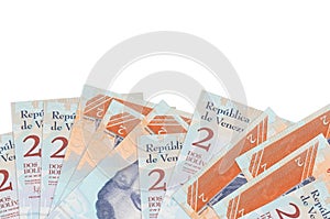 2 Venezuelian bolivar bills lies on bottom side of screen isolated on white background with copy space. Background banner template