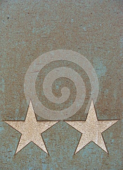 2 white stars on a metal surface