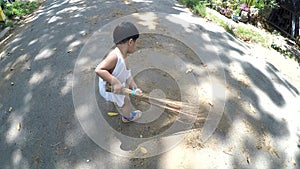 2 year old boy baby sweeping the street