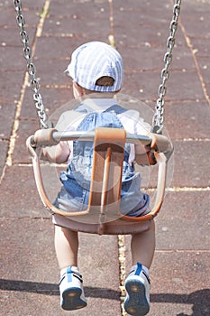 2 year-old boy playing on adapted swing