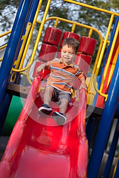 2 year old mixed race boy plays in playground