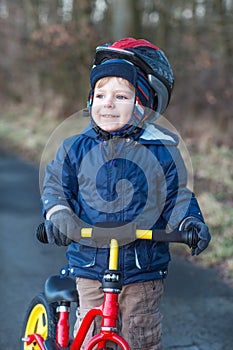 2 years old toddler riding on his first bike