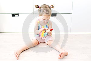 2 years toddler girl with mobile phone at home