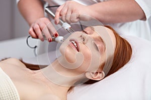 20-25 years old woman receiving a non-surgical rejuvenation procedure