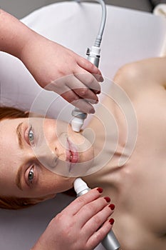 20-25 years old woman receiving a non-surgical rejuvenation procedure