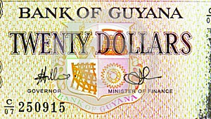 20 Dollars banknote, Bank of Guyana, closeup bill fragment shows Signatures of Governor and Minister of Finance