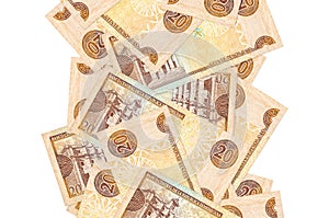 20 Dominican peso bills flying down isolated on white. Many banknotes falling with white copyspace on left and right side