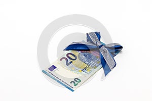 A 20 euro paper banknote decorated with a blue bow on a white background. The concept of a monetary gift, a bonus