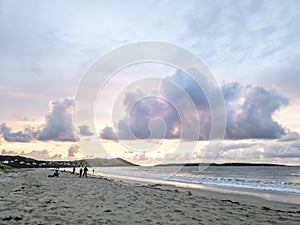 20 man are competing in a fishing competition on the beach.