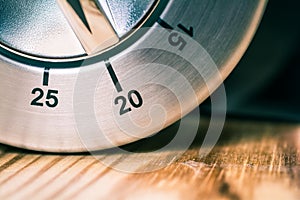 20 Minutes - Macro Of An Analog Chrome Kitchen Timer On Wooden Table