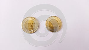 20 rupees coins on white background.