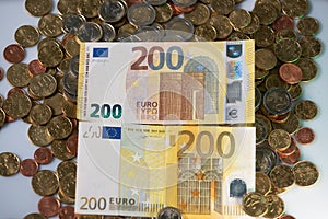 200 hundred Euro Banknotes. New and Old Bills. Euro coins under the Bank notes. European Cash from Central Bank. Two hundred EUR