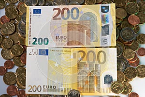 200 hundred Euro Banknotes. New and Old Bills. Euro coins under the Bank notes. European Cash from Central Bank. Two hundred EUR