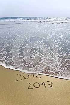 2012 and 2013 written in sand