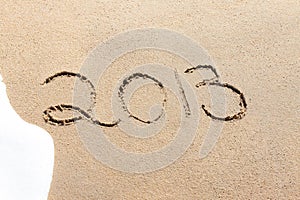 2013 written in the sand on a beach