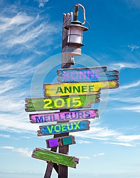 2015 happy new year in French on pastel colored wooden direction signs