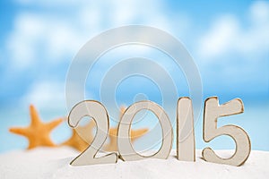 2015 letters with starfish, ocean ,white sand beach