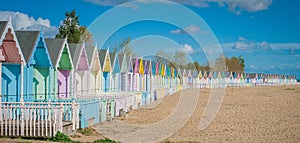 2016 United Kingdom Mersea colorful houses on the coast. Beautiful wide beach with interesting buildings