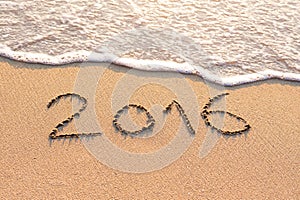 2016 written on a sandy beach for new year concept