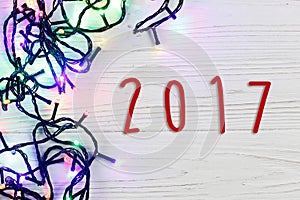 2017 sign text on christmas frame of garland lights. colorful st