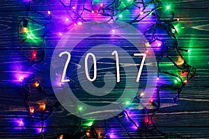 2017 sign text on christmas frame of garland lights. colorful st