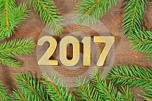 2017 year golden figures and a spruce branch