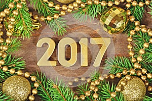 2017 year golden figures and spruce branch and Christmas decoration