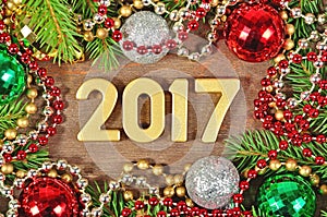 2017 year golden figures and spruce branch and Christmas decoration