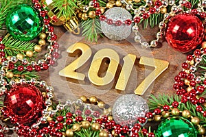 2017 year golden figures and spruce branch and Christmas decoration