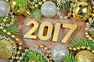 2017 year golden figures and spruce branch and Christmas decorations