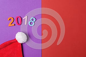 2018 colorful numbers and santa hat on paper backround, minimal style.