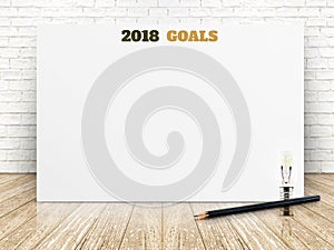 2018 goals of new year on white paper poster on wood plank floor