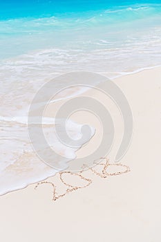 2018 inscription written on sandy beach, New Year greeting card.