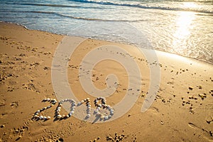 2018 New Year text on sand