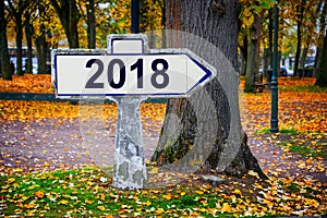 2018 written on an old french roadsign, autumnal background