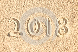 2018 written in the sand of a beach, new year travel